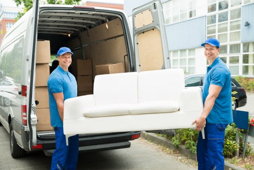 Removal team planning a house move in a narrow Soho street