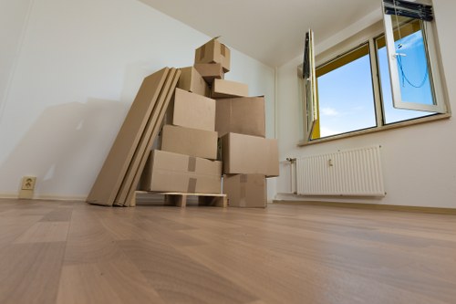 Professional movers handling furniture in a central London office building