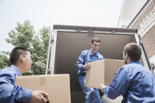 Professional mover carrying boxes near central London properties