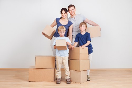 Packed household boxes and furniture ready for transport in Soho