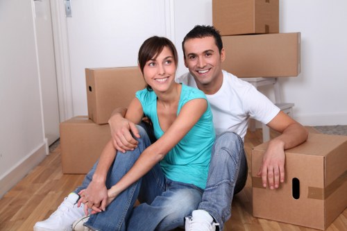 Local removal team handling furniture and boxes in a Soho property